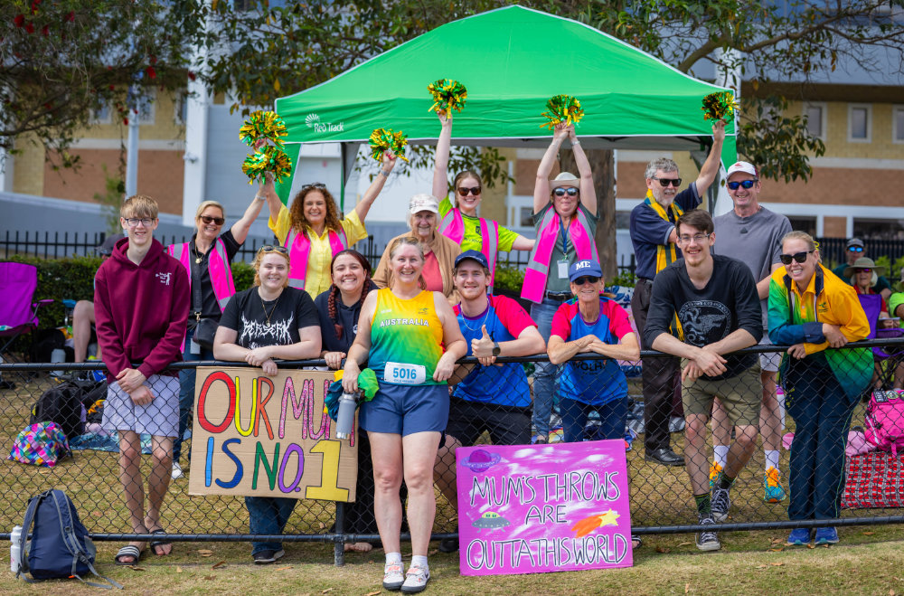 Kylie with her cheer squad at a hammer competition