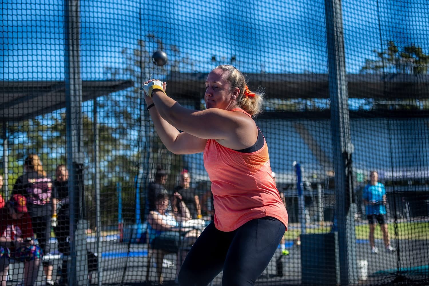 Kath swinging the hammer inside the throwing cage